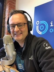 Photo of Brian Ardinger with headphones doing podcast