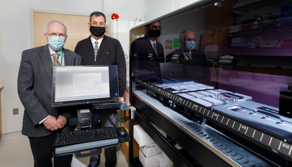 02_09_2021_IwenGeneSequencer002 Peter Iwen, PhD, left, & Abdalhamid Baha, MD, PhD, with Clear Labs GridIron sequencer.