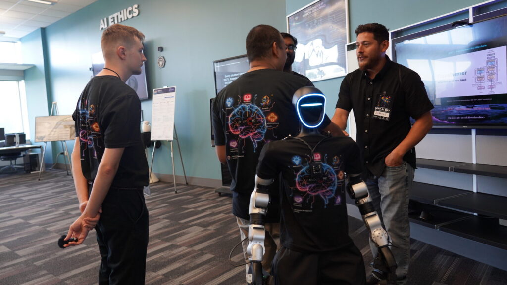 Attendees of Mav AI Day on June 5 gathered in the newly opened exhibit on artificial intelligence located at the Barbara Weitz Community Engagement Center on the University of Nebraska at Omaha campus. The exhibit features robotics and interactive lessons
