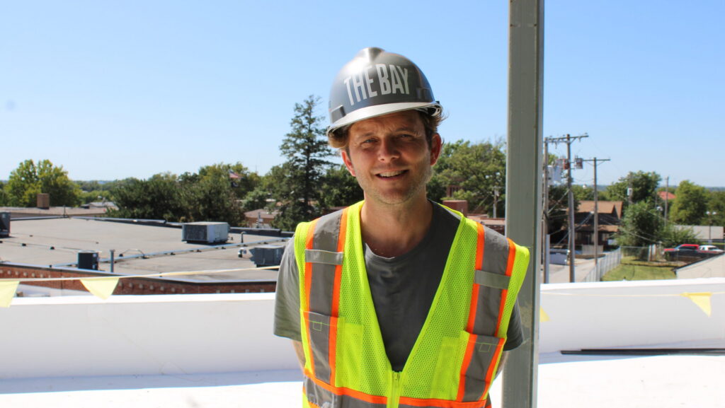 The Bay Executive Director and Co-founder Andrew Norman standing on the roof of the Omaha facility under construction