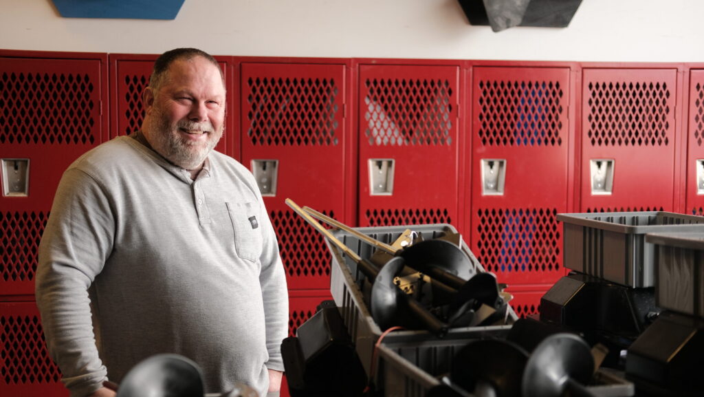 Chad Johnson, co-founder and CEO of Grain Weevil, stands by a workbench with partially disassembled robots sent by clients for inspection and maintenance. Grain Weevil received SBIR funding from the National Science Foundation. Photo by Lev Gringauz/Silicon Prairie News