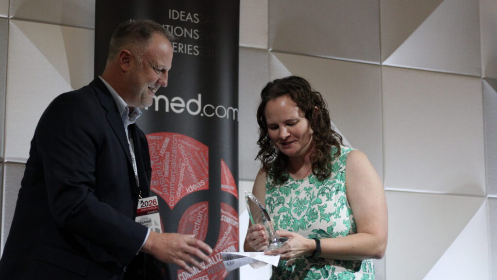 Elizabeth Beam (right), an associate professor at the UNMC College of Nursing, receives the Faculty Entrepreneur of the Year Award from UNeMed President and CEO Michael Dixon on Oct. 14, 2026. Photo by Ben Goeser/Silicon Prairie News